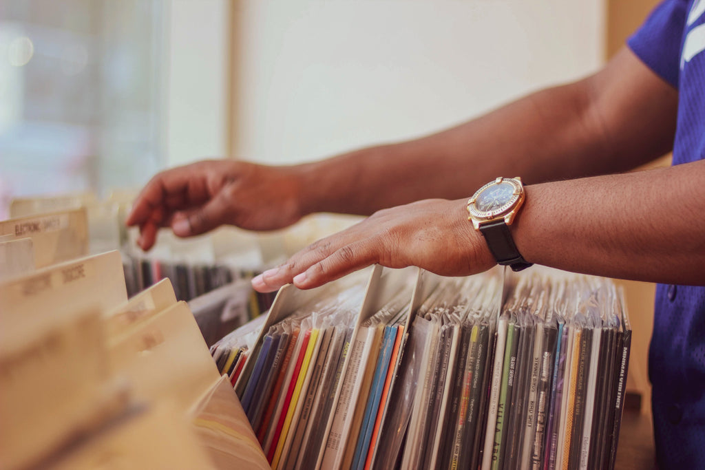 person flicking through vinyl records